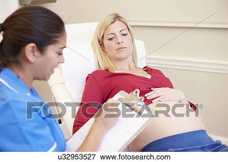 Pregnant Woman Being Given Ante Natal Check By Nurse View Large Photo Image Stock Photo - Pregnant Woman Being Given Ante Natal Check By Nurse. Fotosearch