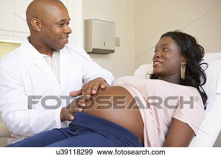 Pregnant Woman Being Given Ante Natal Check By Doctor View Large Photo Image Stock Photo - Pregnant Woman Being Given Ante Natal Check By Doctor. Fotosearch