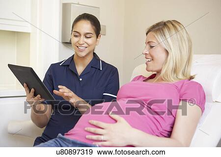 Stock Photo - Pregnant Woman Being Given Ante Natal Check By Nurse. Fotosearch
