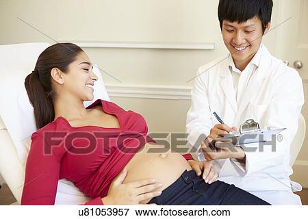 Pregnant Woman Being Given Ante Natal Check By Doctor View Large Photo Image Stock Photo - Pregnant Woman Being Given Ante Natal Check By Doctor. Fotosearch