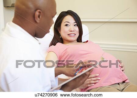 Stock Photograph - Pregnant Woman Being Given Ante Natal Check By Nurse. Fotosearch