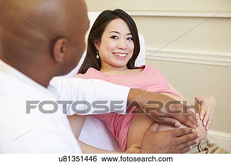Stock Photograph - Pregnant Woman Being Given Ante Natal Check By Doctor. Fotosearch