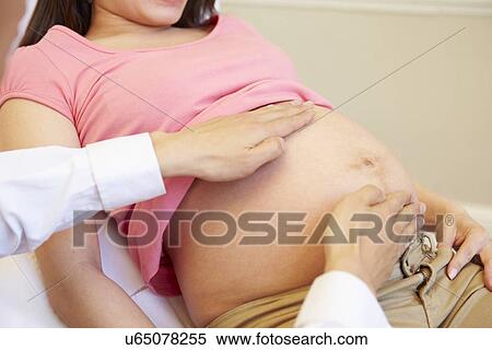 Pregnant Woman Being Given Ante Natal Check By Doctor View Large Photo Image Stock Photography - Pregnant Woman Being Given Ante Natal Check By Doctor. Fotosearch