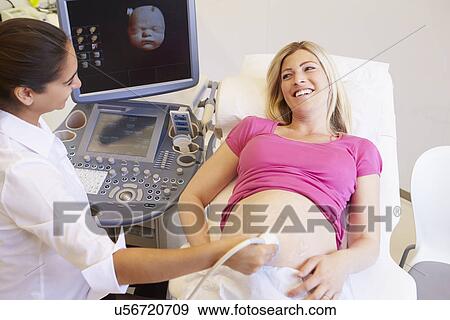 Stock Photo - Pregnant Woman Having 4D Ultrasound Scan. Fotosearch