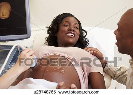 Stock Photography - Pregnant Woman Having 4D Ultrasound Scan. Fotosearch