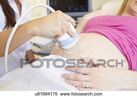 Stock Photography - Pregnant Woman Having 4D Ultrasound Scan. Fotosearch