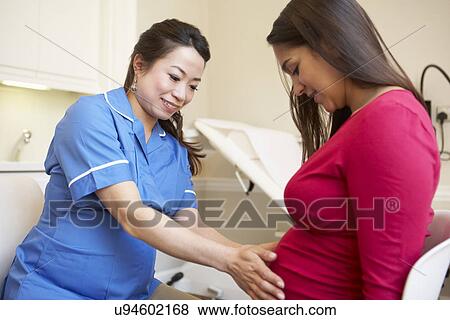 Pregnant Woman Meeting With Nurse In Clinic View Large Photo Image Stock Photo - Pregnant Woman Meeting With Nurse In Clinic. Fotosearch