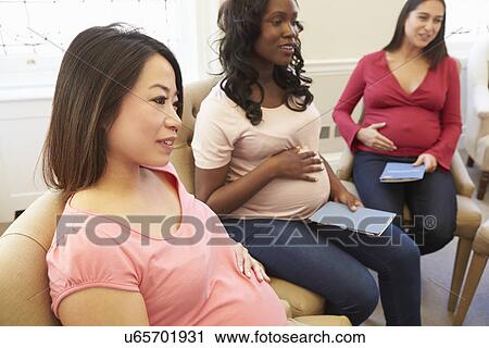 Stock Image - Pregnant Women Meeting At Ante Natal Class. Fotosearch