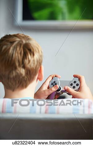 Rear View Of Boy Holding Controller Playing Video Game View Large Photo Image Picture - Rear View Of Boy Holding Controller Playing Video Game. Fotosearch