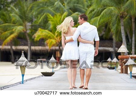 Rear View Of Couple Walking On Wooden Jetty View Large Photo Image Stock Photo - Rear View Of Couple Walking On Wooden Jetty. Fotosearch
