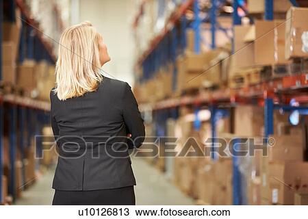 Rear View Of Female Manager In Warehouse View Large Photo Image Stock Image - Rear View Of Female Manager In Warehouse. Fotosearch