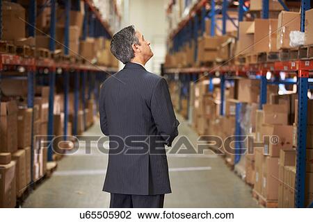Rear View Of Manager In Warehouse View Large Photo Image Stock Image - Rear View Of Manager In Warehouse. Fotosearch