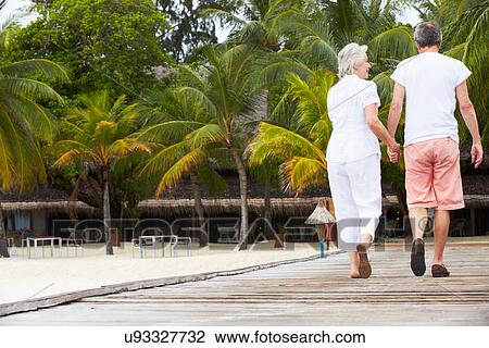 Rear View Of Senior Couple Walking On Wooden Jetty View Large Photo Image Stock Image - Rear View Of Senior Couple Walking On Wooden Jetty. Fotosearch
