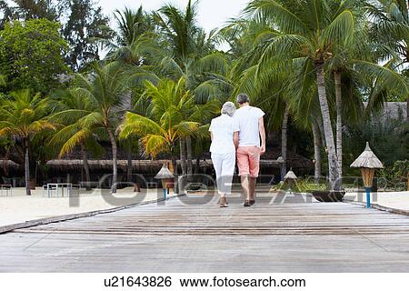 Rear View Of Senior Couple Walking On Wooden Jetty View Large Photo Image Stock Photograph - Rear View Of Senior Couple Walking On Wooden Jetty. Fotosearch