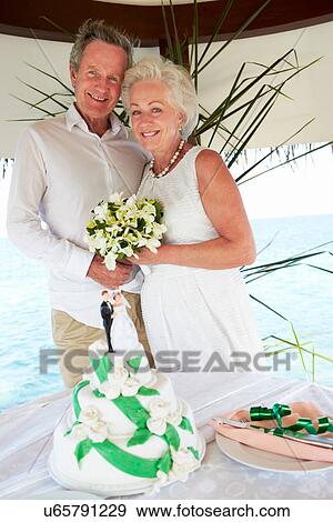 Senior Beach Wedding Ceremony With Cake In Foreground View Large Photo Image Stock Photo - Senior Beach Wedding Ceremony With Cake In Foreground. Fotosearch