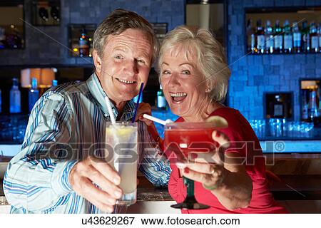 Senior Couple Enjoying Cocktail In Bar View Large Photo Image Stock Photo - Senior Couple Enjoying Cocktail In Bar. Fotosearch
