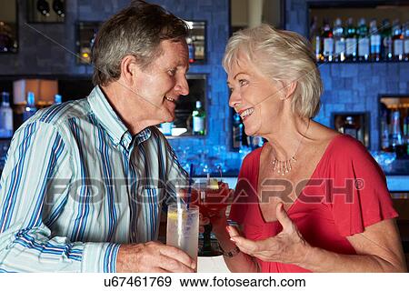 Senior Couple Enjoying Cocktail In Bar View Large Photo Image Stock Photo - Senior Couple Enjoying Cocktail In Bar. Fotosearch