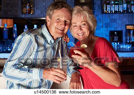 Senior Couple Enjoying Cocktail In Bar View Large Photo Image Stock Photograph - Senior Couple Enjoying Cocktail In Bar. Fotosearch