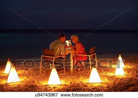 Stock Photo - Senior Couple Enjoying Late Meal In Outdoor Restaurant. Fotosearch