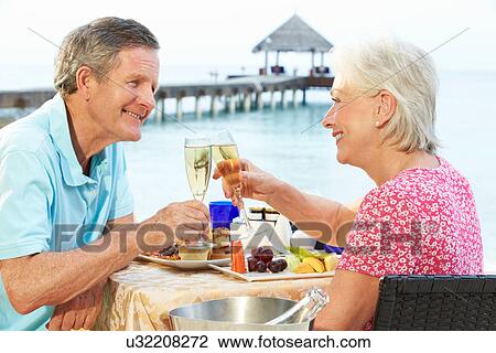 Senior Couple Enjoying Meal In Seafront Restaurant View Large Photo Image Stock Image - Senior Couple Enjoying Meal In Seafront Restaurant. Fotosearch