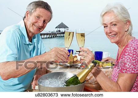Senior Couple Enjoying Meal In Seafront Restaurant View Large Photo Image Stock Image - Senior Couple Enjoying Meal In Seafront Restaurant. Fotosearch