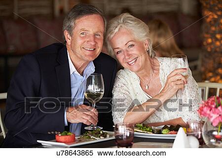 Senior Couple Enjoying Meal In Restaurant View Large Photo Image Stock Photography - Senior Couple Enjoying Meal In Restaurant. Fotosearch