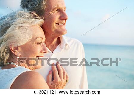 Stock Image - Senior Couple Getting Married In Beach Ceremony. Fotosearch