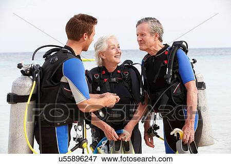 Stock Photo - Senior Couple Having Scuba Diving Lesson With Instructor. Fotosearch