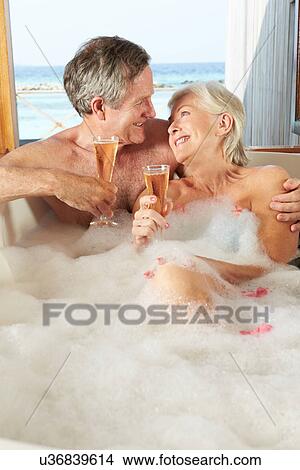Senior Couple Relaxing In Bath Drinking Champagne Together View Large Photo Image Picture - Senior Couple Relaxing In Bath Drinking Champagne Together. Fotosearch