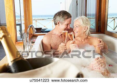 Senior Couple Relaxing In Bath Drinking Champagne Together View Large Photo Image Stock Image - Senior Couple Relaxing In Bath Drinking Champagne Together. Fotosearch