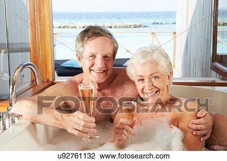Senior Couple Relaxing In Bath Drinking Champagne Together View Large Photo Image Stock Image - Senior Couple Relaxing In Bath Drinking Champagne Together. Fotosearch