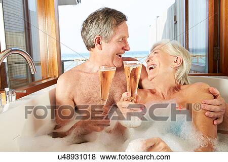 Senior Couple Relaxing In Bath Drinking Champagne Together View Large Photo Image Stock Photo - Senior Couple Relaxing In Bath Drinking Champagne Together. Fotosearch