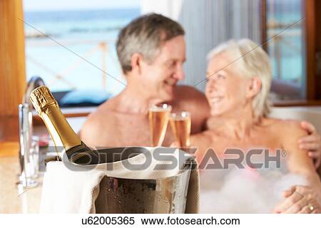Senior Couple Relaxing In Bath Drinking Champagne Together View Large Photo Image Stock Photography - Senior Couple Relaxing In Bath Drinking Champagne Together. Fotosearch
