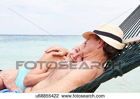 Senior Couple Relaxing In Beach Hammock View Large Photo Image Stock Image - Senior Couple Relaxing In Beach Hammock . Fotosearch
