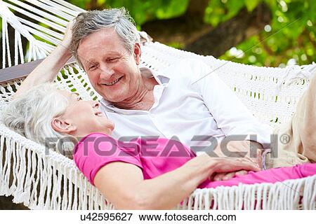 Senior Couple Relaxing In Beach Hammock View Large Photo Image Stock Photo - Senior Couple Relaxing In Beach Hammock. Fotosearch