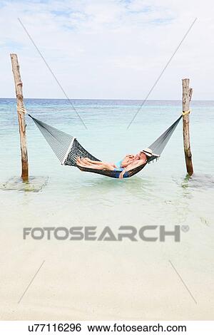 Senior Couple Relaxing In Beach Hammock View Large Photo Image Stock Photograph - Senior Couple Relaxing In Beach Hammock . Fotosearch
