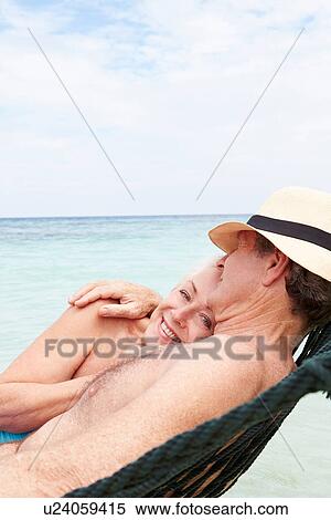 Stock Photography - Senior Couple Relaxing In Beach Hammock . Fotosearch