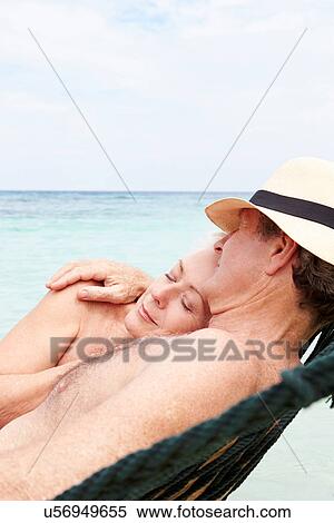 Senior Couple Relaxing In Beach Hammock View Large Photo Image Stock Photography - Senior Couple Relaxing In Beach Hammock . Fotosearch