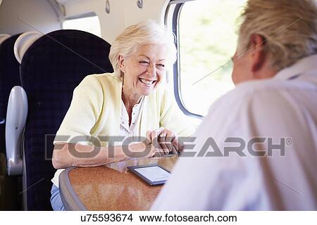 Picture - Senior Couple Relaxing On Train Journey. Fotosearch
