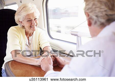 Senior Couple Relaxing On Train Journey View Large Photo Image Stock Image - Senior Couple Relaxing On Train Journey. Fotosearch