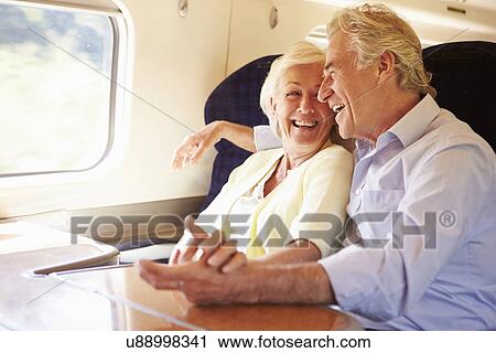 Senior Couple Relaxing On Train Journey View Large Photo Image Stock Image - Senior Couple Relaxing On Train Journey. Fotosearch