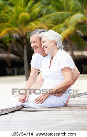 Senior Couple Sitting On Wooden Jetty View Large Photo Image Picture - Senior Couple Sitting On Wooden Jetty. Fotosearch