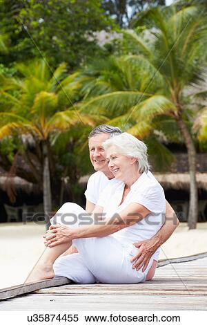 Senior Couple Sitting On Wooden Jetty View Large Photo Image Stock Photography - Senior Couple Sitting On Wooden Jetty. Fotosearch