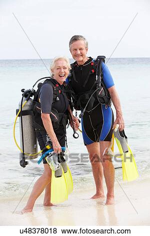Senior Couple With Scuba Diving Equipment Enjoying Holiday View Large Photo Image Stock Photo - Senior Couple With Scuba Diving Equipment Enjoying Holiday. Fotosearch