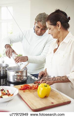 Senior Indian Couple Cooking Meal At Home View Large Photo Image Stock Photo - Senior Indian Couple Cooking Meal At Home. Fotosearch
