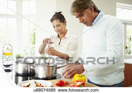 Senior Indian Couple Cooking Meal At Home View Large Photo Image Stock Photo - Senior Indian Couple Cooking Meal At Home. Fotosearch