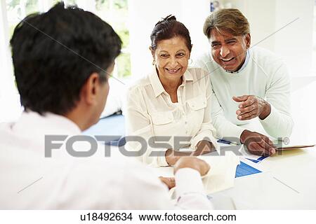 Picture - Senior Indian Couple Meeting With Financial Advisor At Home. Fotosearch