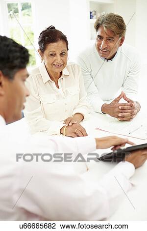 Senior Indian Couple Meeting With Financial Advisor At Home View Large Photo Image Stock Image - Senior Indian Couple Meeting With Financial Advisor At Home. Fotosearch