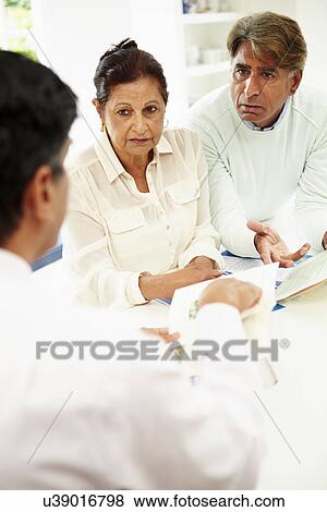 Senior Indian Couple Meeting With Financial Advisor At Home View Large Photo Image Stock Photo - Senior Indian Couple Meeting With Financial Advisor At Home. Fotosearch