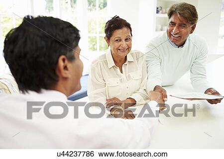 Senior Indian Couple Meeting With Financial Advisor At Home View Large Photo Image Stock Photograph - Senior Indian Couple Meeting With Financial Advisor At Home. Fotosearch